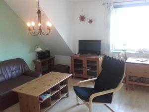 Im Wohnzimmer finden Sie einen Sat- Fernseher, DVD- Player und eine Musikanlage. Die Couch lässt sich für zwei Personen zum Schlafen ausziehen. - Bild 15: Ferienhof Schmiddes, Fewo Spatzennest