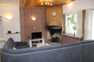 Die gemütliche Sitzecke im Wohnbereich mit dem elektrischen Kamin und Blick ins Grüne. - Bild 3: Ferienwohnung EifelNatur 5 - gemütliche FeWo im Landhausstil